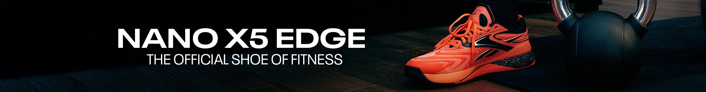 Banner desktop secci&oacute;n Reebok Nano X5 Edge, par de tenis crossfit naranja ne&oacute;n con detalles negros y plateados sobre colchoneta de gimnasio, calcetines negros con logo Reebok, texto Nano X5 Edge The Official Shoe of Fitness, fondo de piso de madera y equipo de entrenamiento oscuro.