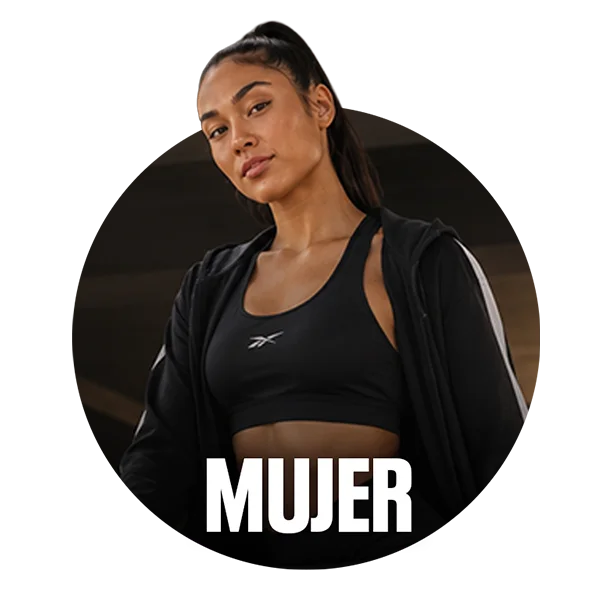 Card circular de categor&iacute;a Mujer Reebok, modelo femenina con coleta, top deportivo negro con logo Reebok Vector y sudadera negra con franjas blancas, fondo oscuro de gimnasio, texto Mujer en blanco. Ropa deportiva de mujer Reebok.